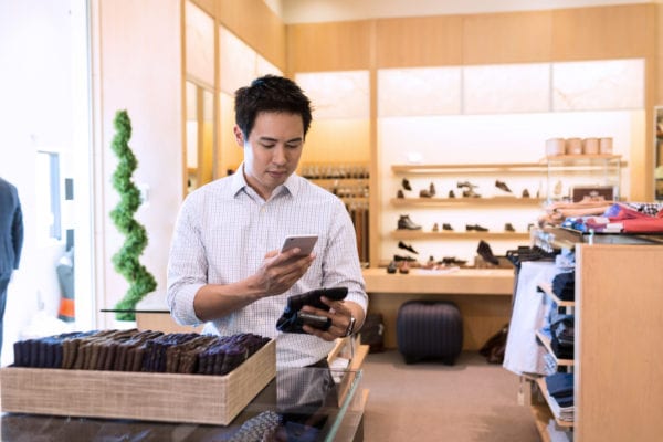 Customer using phone in store