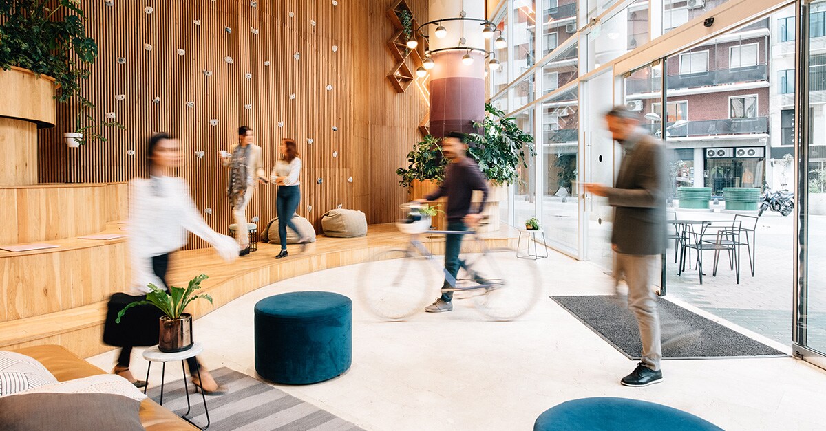 various people walking through an office lobby