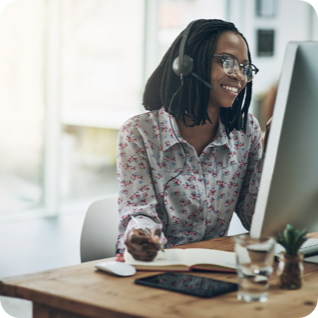 Woman with a headset on working at a desk 