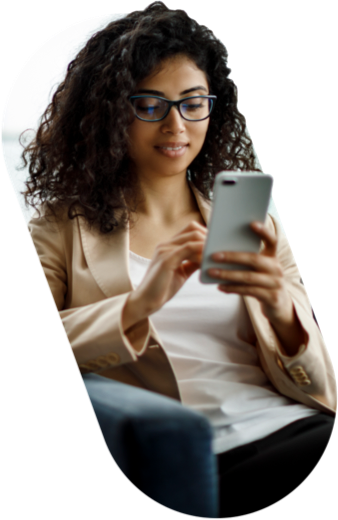 Woman in a tan blazer looking at her cellphone