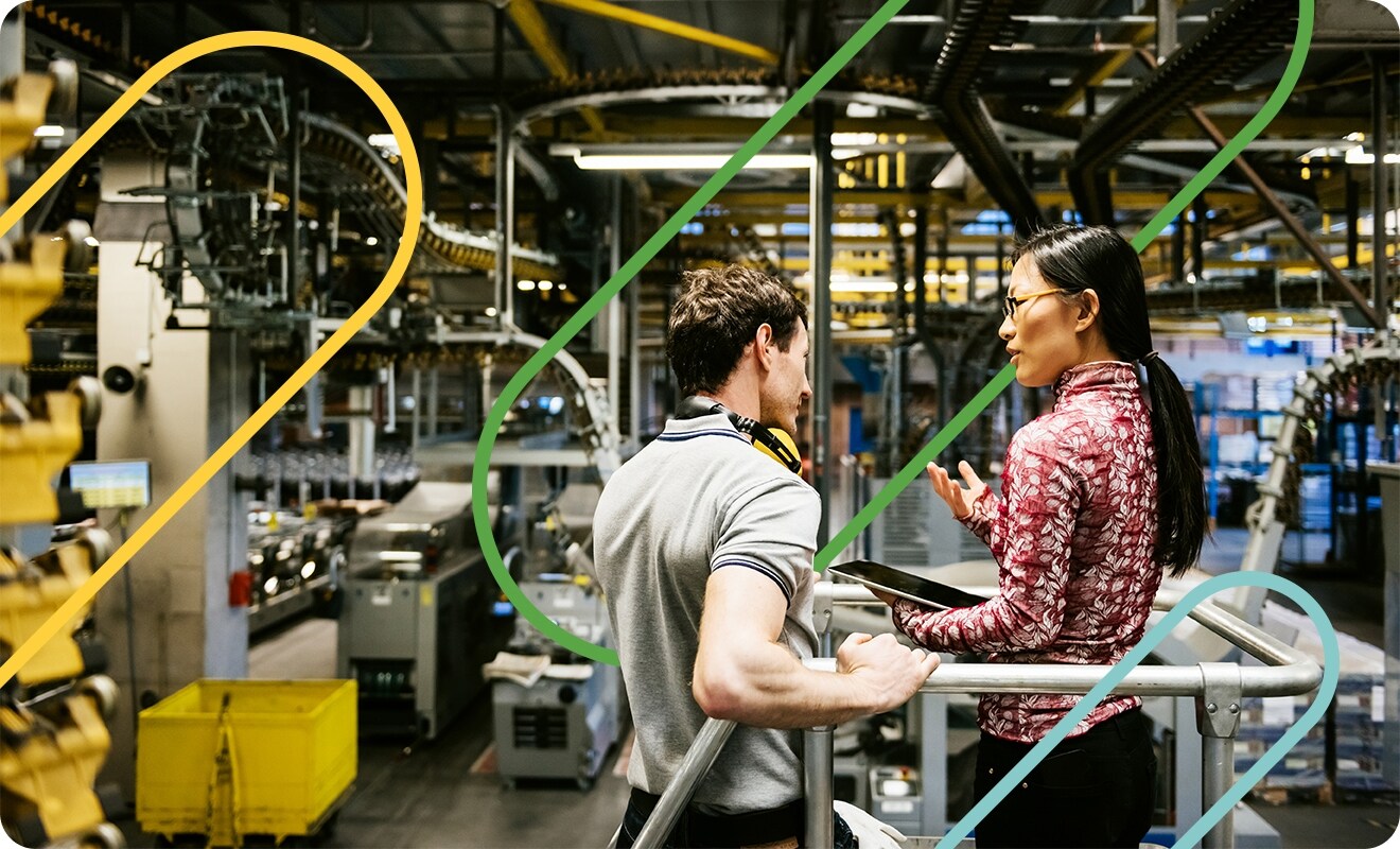 Two people in a manufacturing building